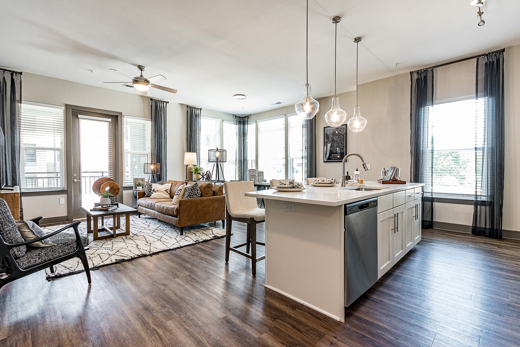 Kitchen with island seating and view of open living and dining