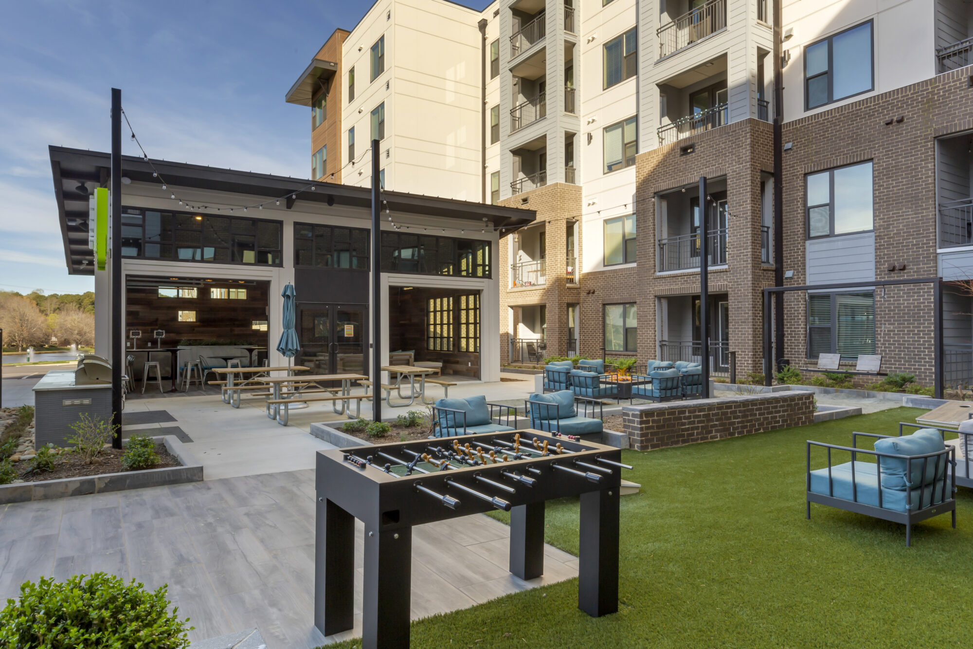 Courtyard with outdoor grills, fire pit, and shaded sitting area